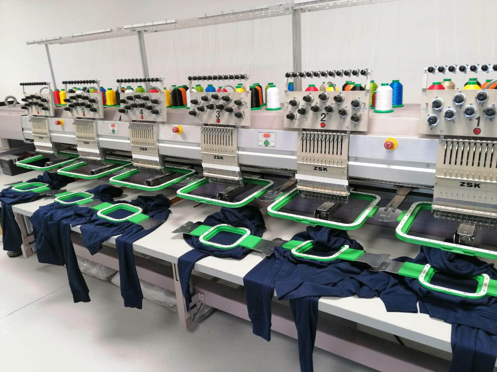 An industrial embroidery machine stitching a complex design.